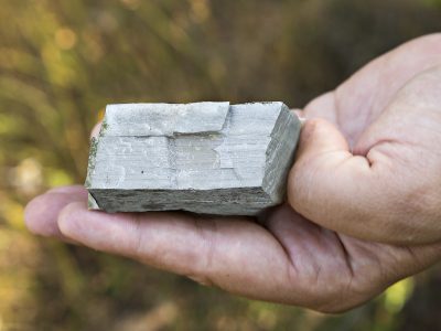 0S0A1157 image of a hand holding a small, grey rock